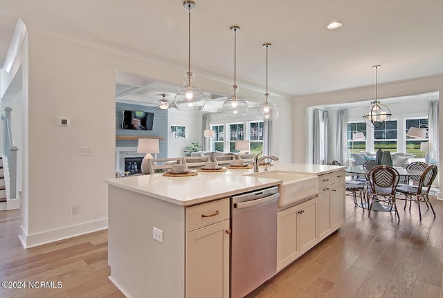 1024 Peace St Lot 73, Leland, NC 28451 - kitchen with stainless steel dishwasher, open floor plan, a sink, light wood-type flooring, and a kitchen island with sink