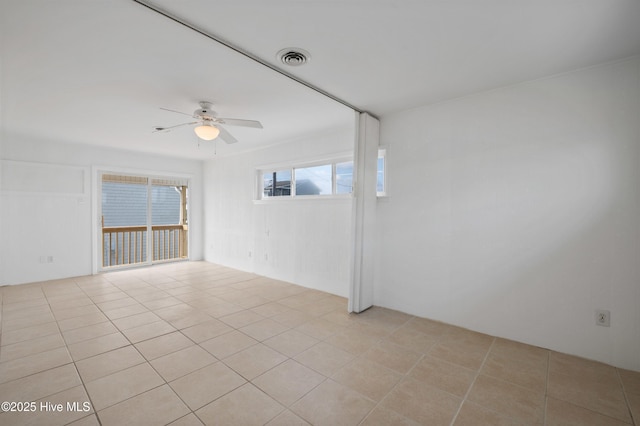 spare room featuring light tile patterned floors and ceiling fan