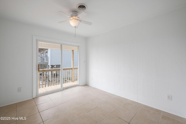 tiled empty room featuring ceiling fan