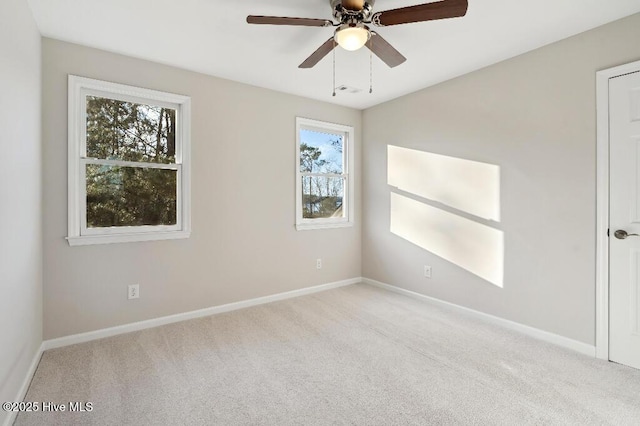 spare room with light carpet and ceiling fan