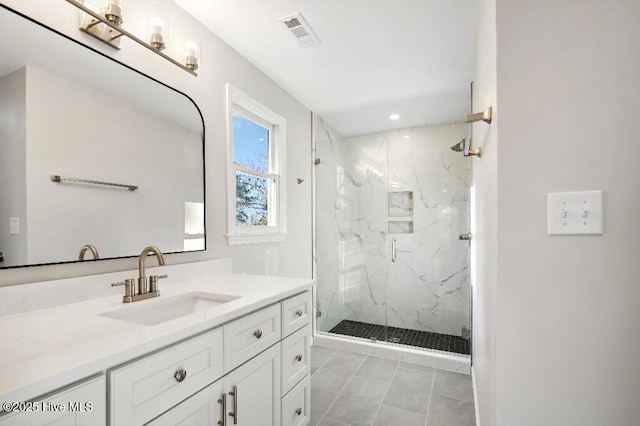 bathroom featuring vanity and a shower with door