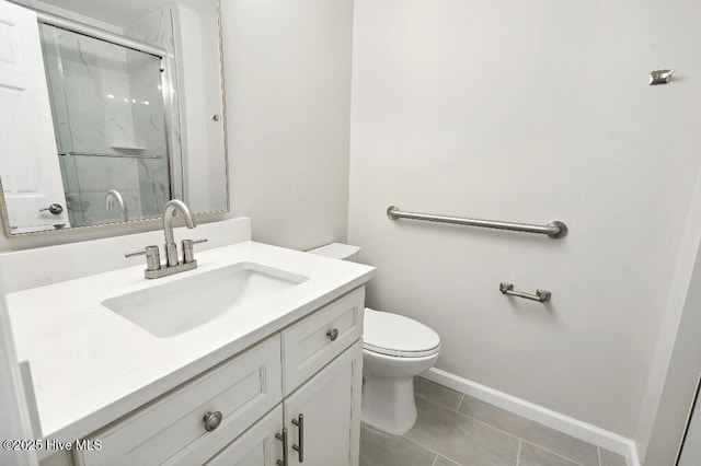 bathroom featuring tile patterned flooring, toilet, vanity, and a shower with shower door