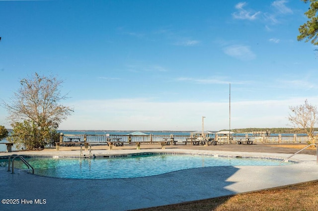 view of pool featuring a water view