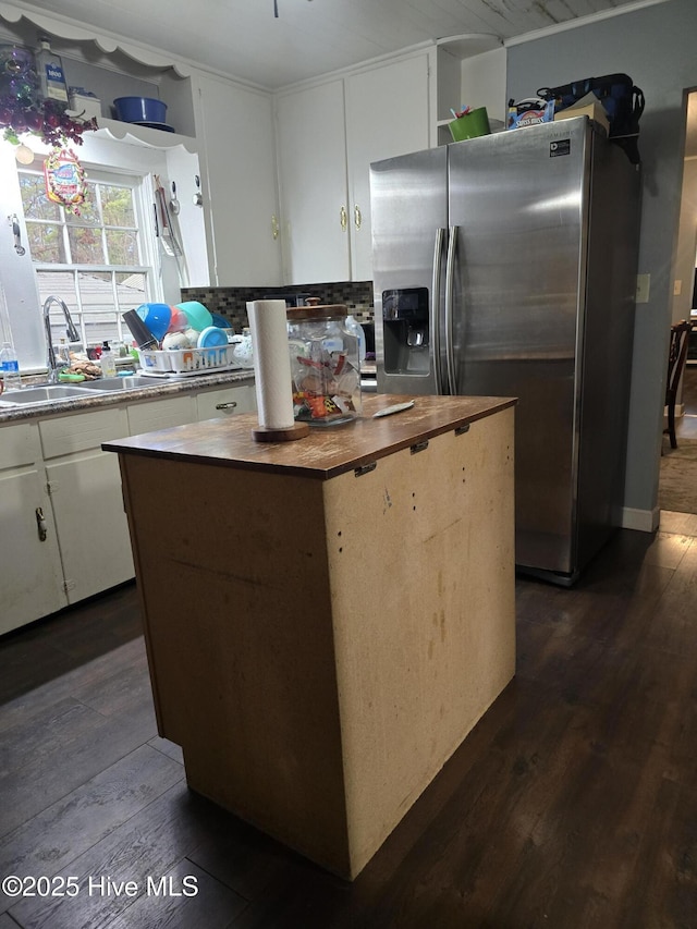 kitchen featuring sink, dark wood-type flooring, a center island, white cabinets, and stainless steel fridge with ice dispenser