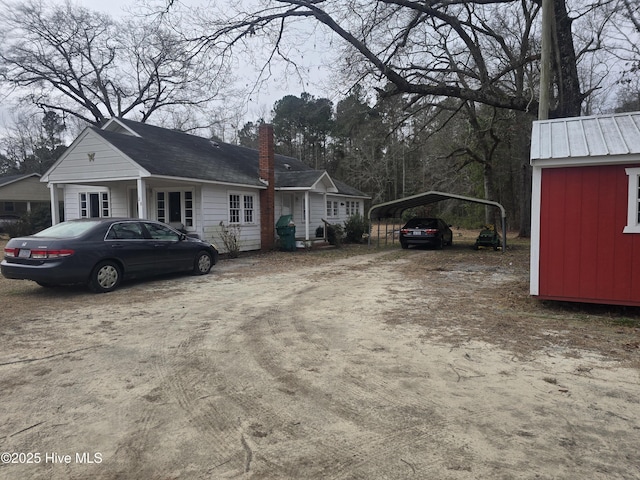 view of side of property with a carport