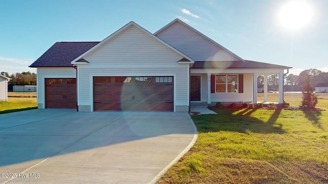 view of front of property featuring a garage and a front lawn