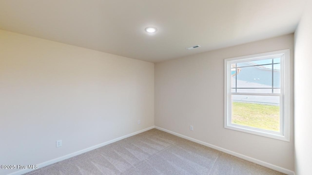 empty room with light colored carpet