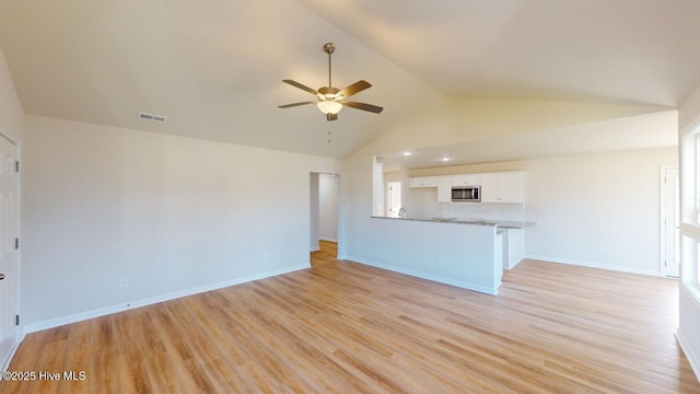unfurnished living room with ceiling fan, high vaulted ceiling, and light hardwood / wood-style floors