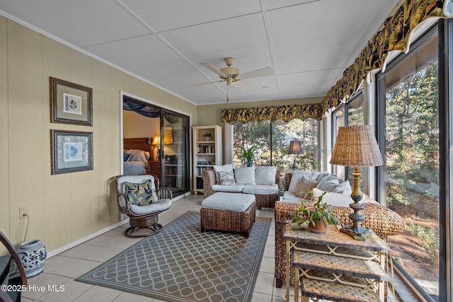 sunroom / solarium featuring a ceiling fan