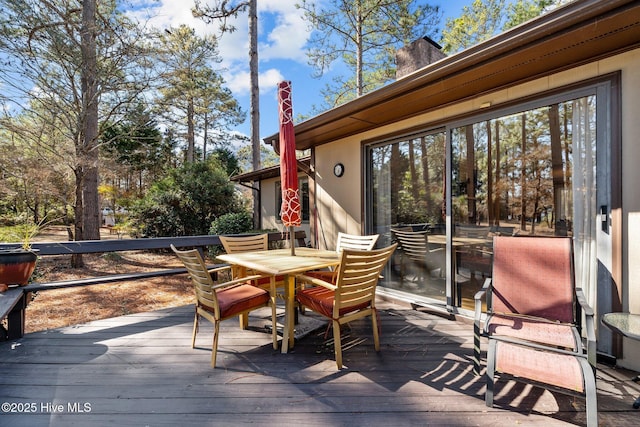 wooden deck with outdoor dining space