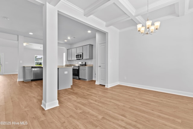 interior space featuring coffered ceiling, light hardwood / wood-style flooring, ornamental molding, beamed ceiling, and ceiling fan with notable chandelier