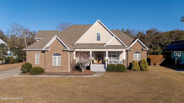 108 Casey Ct, Cedar Point, NC 28584 - view of front of house with covered porch, brick siding, and a shingled roof