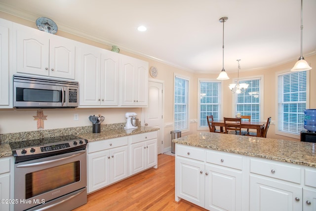 108 Casey Ct, Cedar Point, NC 28584 - kitchen featuring appliances with stainless steel finishes, a chandelier, light wood-type flooring, crown molding, and white cabinetry