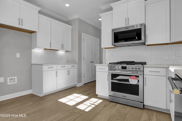 kitchen with white cabinetry, appliances with stainless steel finishes, and light hardwood / wood-style floors