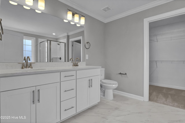 bathroom with crown molding, vanity, toilet, and a shower with door