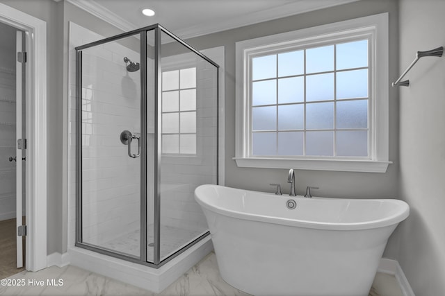 bathroom featuring crown molding and separate shower and tub