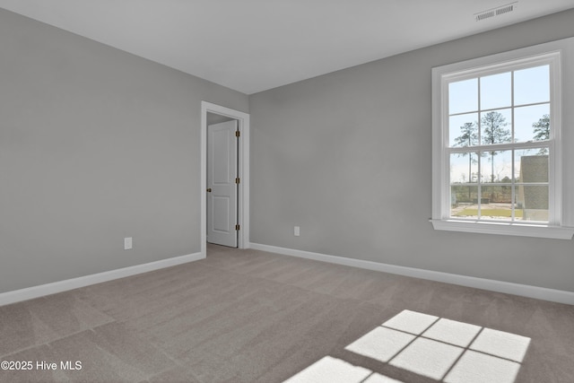 unfurnished room featuring light colored carpet