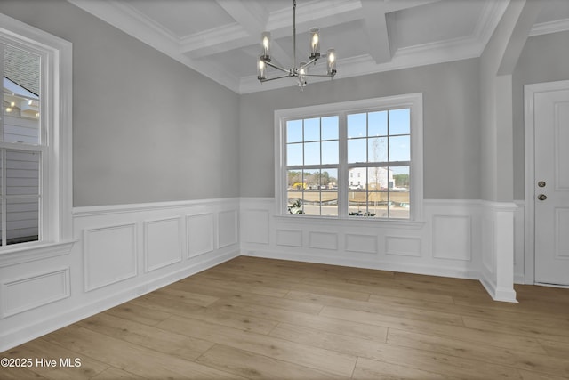 unfurnished dining area with coffered ceiling, light hardwood / wood-style flooring, a chandelier, and beamed ceiling