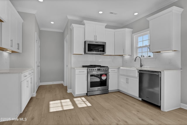 kitchen featuring white cabinetry, appliances with stainless steel finishes, and light wood-type flooring