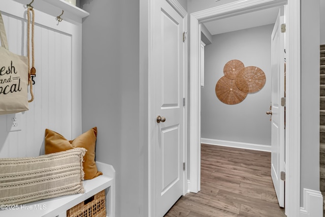 mudroom with baseboards and wood finished floors