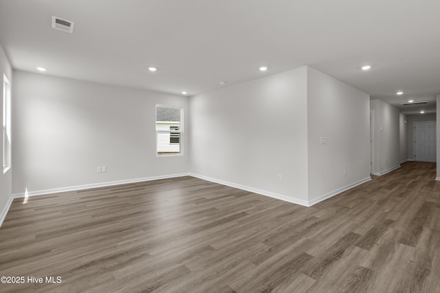 6986 Seaside Palms Pl SW, Sunset Beach, NC 28468 - spare room featuring wood finished floors and recessed lighting