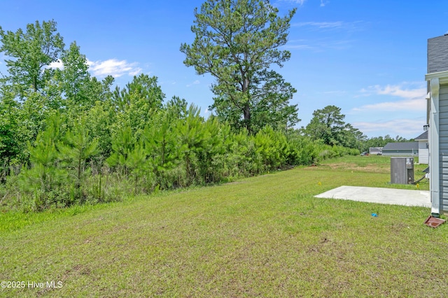 6986 Seaside Palms Pl SW, Sunset Beach, NC 28468 - view of grassy yard with a patio