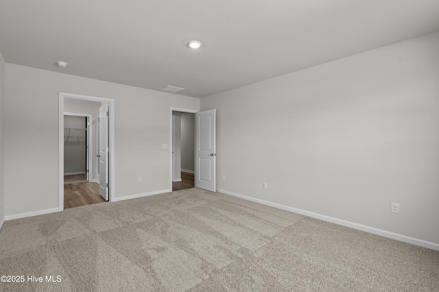 6986 Seaside Palms Pl SW, Sunset Beach, NC 28468 - unfurnished bedroom featuring carpet floors, a spacious closet, and a closet