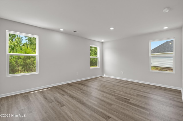 6986 Seaside Palms Pl SW, Sunset Beach, NC 28468 - unfurnished room featuring a smoke detector, wood finished floors, and recessed lighting