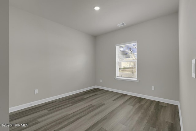 unfurnished room with hardwood / wood-style floors