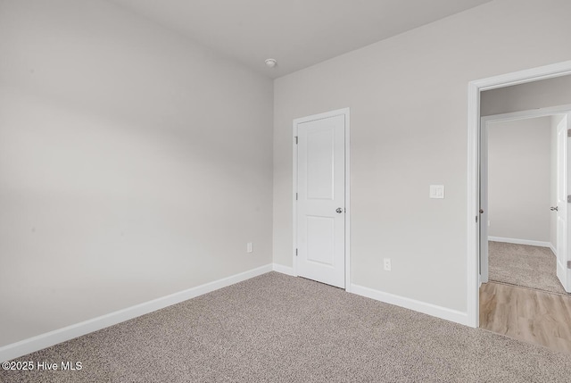 unfurnished bedroom with light colored carpet