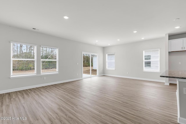 unfurnished living room with light hardwood / wood-style flooring