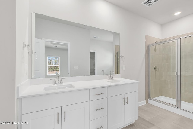 bathroom with vanity and a shower with shower door