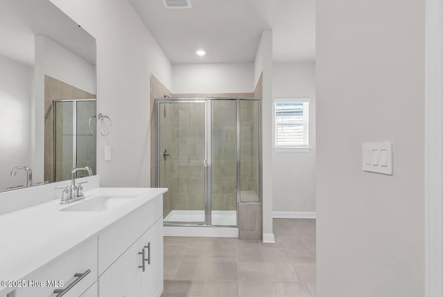 bathroom featuring vanity, an enclosed shower, and tile patterned flooring