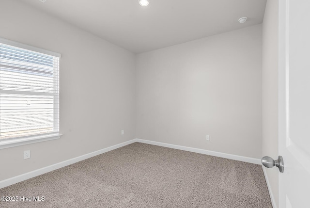 spare room featuring a healthy amount of sunlight and carpet