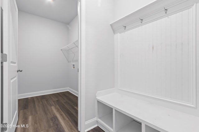 mudroom featuring dark wood-style floors and baseboards