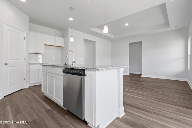 kitchen with dishwasher, a tray ceiling, dark wood-style flooring, and a sink