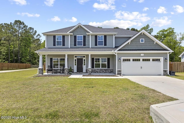 craftsman inspired home with fence, covered porch, concrete driveway, and stone siding