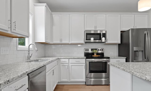 311 Mckenzie Pl, Sneads Ferry, NC 28460 - kitchen with appliances with stainless steel finishes, a sink, and white cabinets