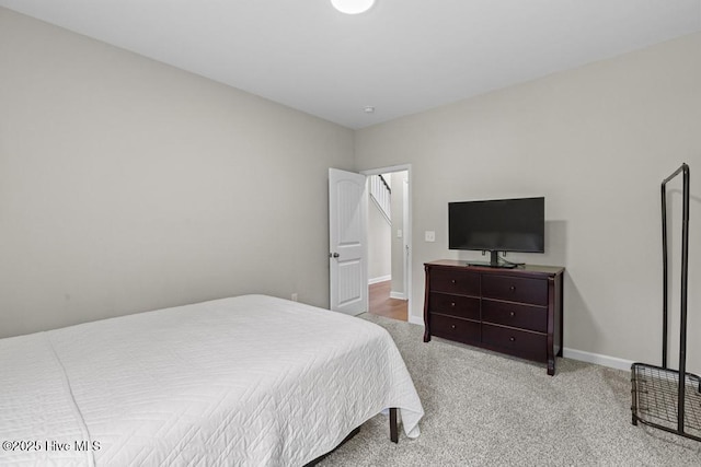 bedroom with baseboards and carpet