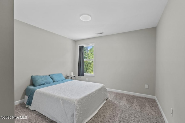 carpeted bedroom featuring baseboards and visible vents