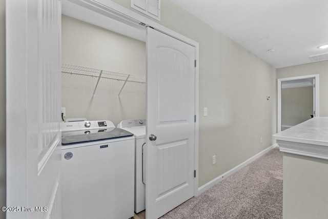 laundry room featuring laundry area, visible vents, light carpet, baseboards, and independent washer and dryer