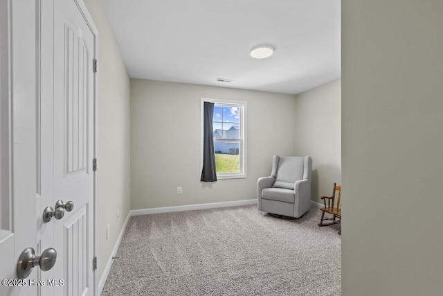 living area featuring carpet floors, baseboards, and visible vents