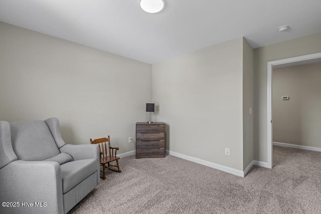 sitting room with baseboards and carpet