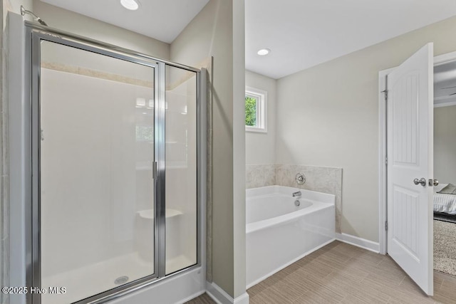 full bathroom featuring a garden tub, baseboards, ensuite bathroom, recessed lighting, and a stall shower