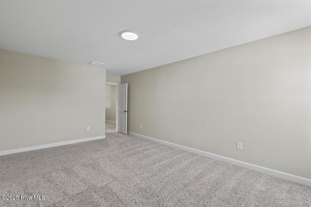 unfurnished room with carpet floors and baseboards