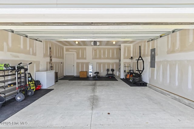 garage featuring a garage door opener, electric panel, and refrigerator