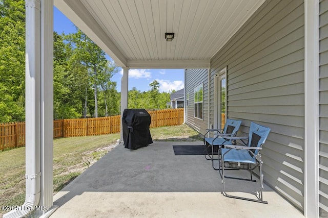 view of patio with grilling area and a fenced backyard