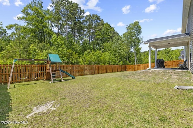 view of yard featuring a fenced backyard and a playground