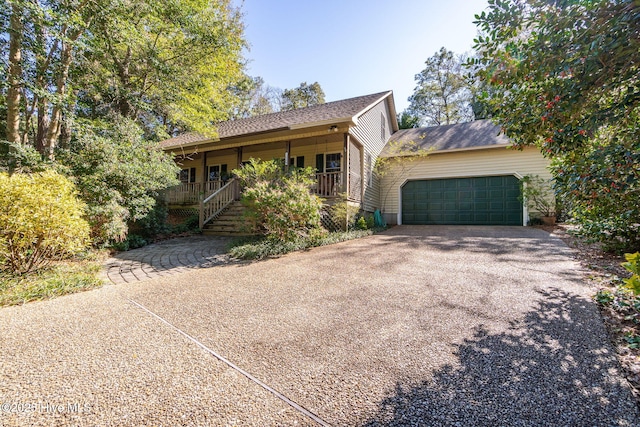 ranch-style house with covered porch and driveway