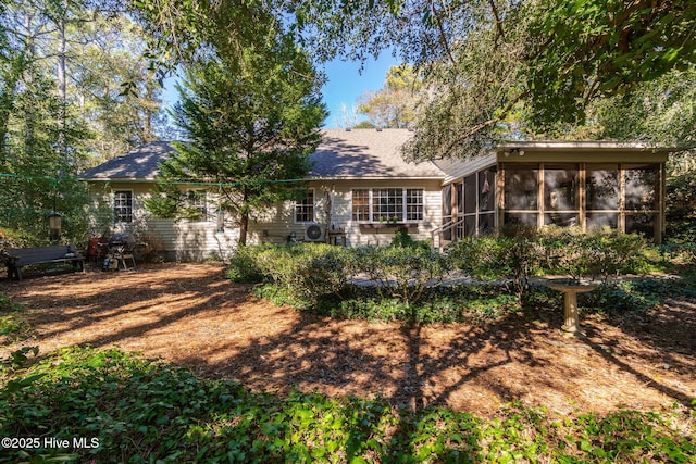 back of house featuring a sunroom